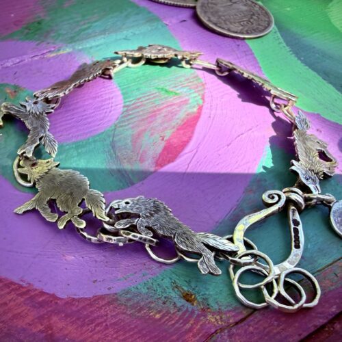 Wolf bracelet made from recycled silver shillings. A pack of wolves racing around your wrist.