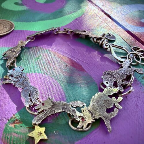 Wolf bracelet made from recycled silver shillings. A pack of wolves racing around your wrist.