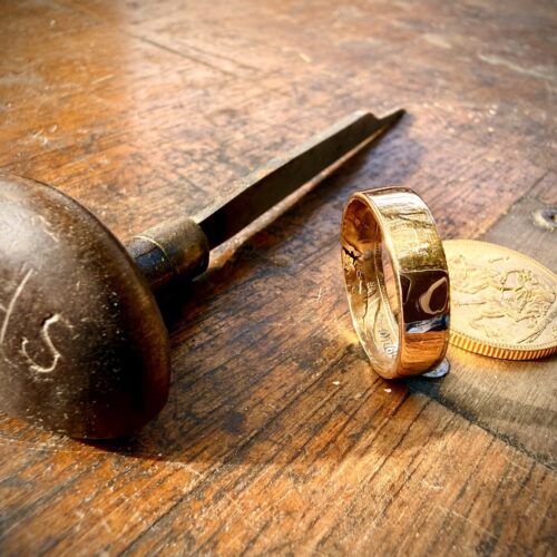 Gold ring, coin, and tool.