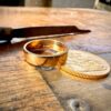 Gold ring beside a gold coin