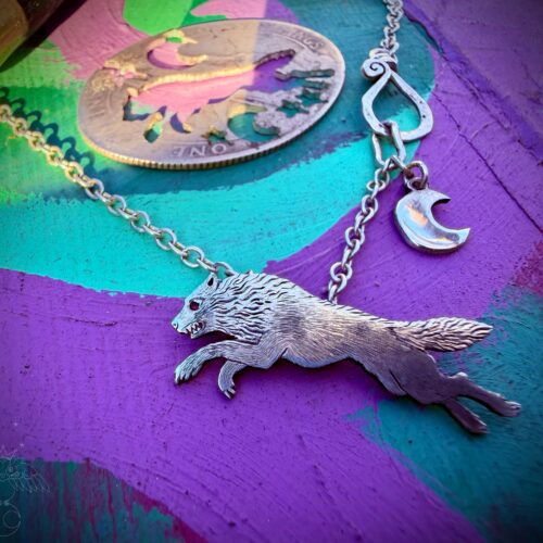 hungry like the wold necklace made from sterling silver recycled from and old silver coin and a lovely ruby eye