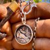 where the tide rests grey seal pendant with lighthouse made from silver shillings seahorses, northumberland
