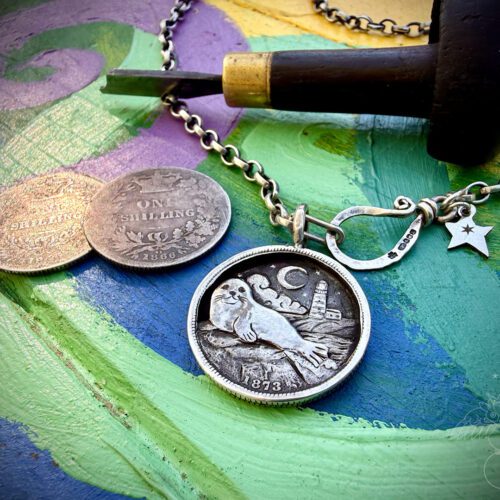 where the tide rests grey seal pendant with lighthouse made from silver shillings seahorses, northumberland