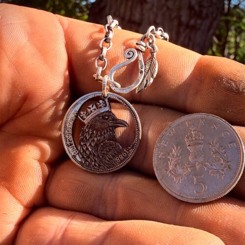 upcycled coin necklace pendant of tower raven